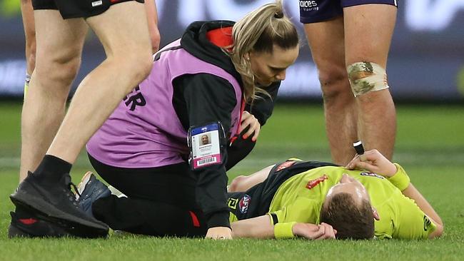 Field umpire Alex Whetton is attended to after a heavy hit. Picture: Getty Images