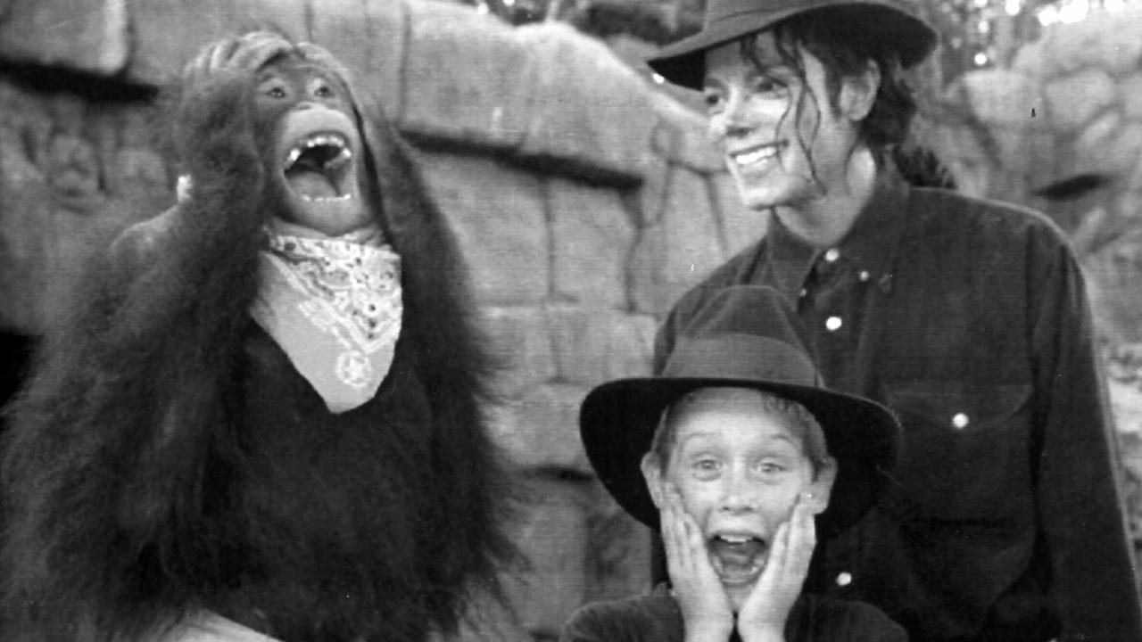 Michael Jackson and Macaulay Culkin monkey around with Ginny the orang-utan at Universal Studios.