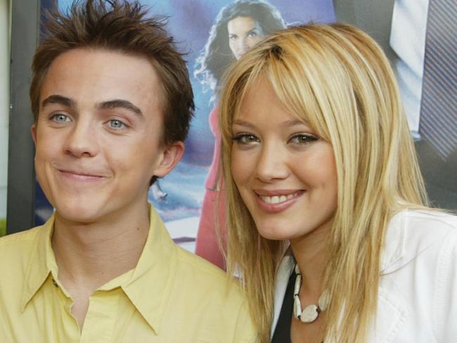 WESTWOOD, CA - MARCH 8: (L to R) Actors Angie Harmon, Frankie Muniz and Hilary Duff  arrive arrive for the premiere of the film "Agent Cody Banks" at the Mann Village Theatre Westwood, on March 8, 2003, Westwood, California. (Photo Frazer by Harrison/Getty Images)