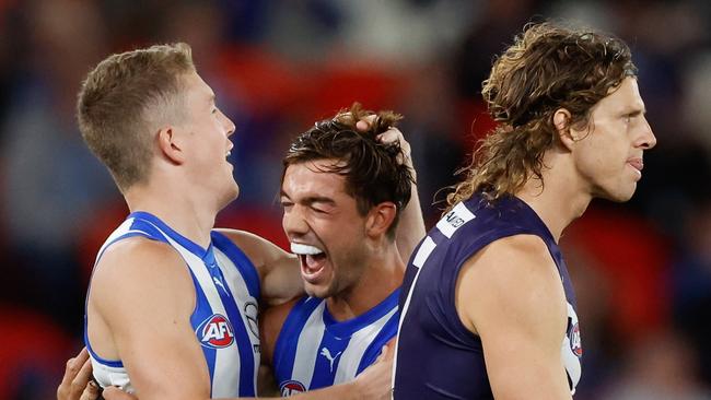 MELBOURNE, AUSTRALIA - MARCH 23: Tom Powell of the Kangaroos (L) celebrates a goal with teammate Jy Simpkin during the 2024 AFL Round 2 match between the North Melbourne Kangaroos and the Fremantle Dockers on March 23, 2024 in Melbourne, Australia. (Photo by Dylan Burns/AFL Photos via Getty Images)