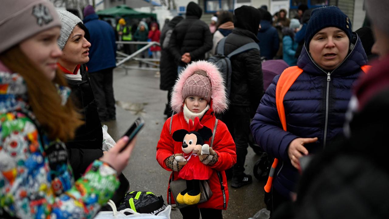 A young refugee girl from Ukraine waits to enter a bus at the Moldova-Ukrainian border's checkpoint. Picture: AFP