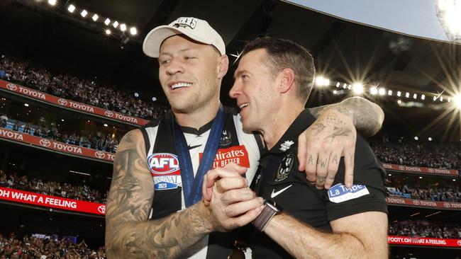MELBOURNE, AUSTRALIA - SEPTEMBER 30: Jordan De Goey of the Magpies and Craig McRae, Senior Coach of the Magpies embrace after the 2023 AFL Grand Final match between Collingwood Magpies and Brisbane Lions at Melbourne Cricket Ground, on September 30, 2023, in Melbourne, Australia. (Photo by Darrian Traynor/AFL Photos/via Getty Images)