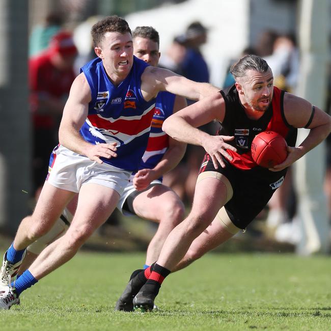 Waaia’s Dylan Moncur is hotly pursued by Strathmerton’s Nicholas Hoban.