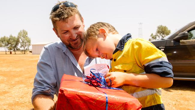 Michael Burford with son Brock, 5, who had just received a present donated from a primary school. Picture: AAP Image/Morgan Sette