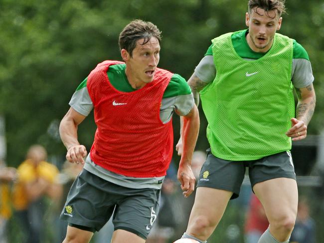 Socceroos train ahead of their Asian Cup opener at Olympic Park, Mark Milligan gets around Chris Herd. Melbourne. 4th January 2015. Picture: Colleen Petch.