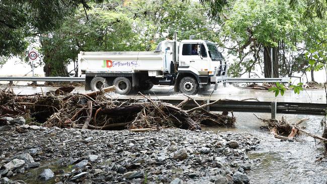 Debris including mud, rocks and tree vegetation completely cut the Captain Cook Highway at Ellis Beach, with flooding caused by Tropical Cyclone Jasper creating devastating scenes at Ellis Beach for residents. Picture: Brendan Radke