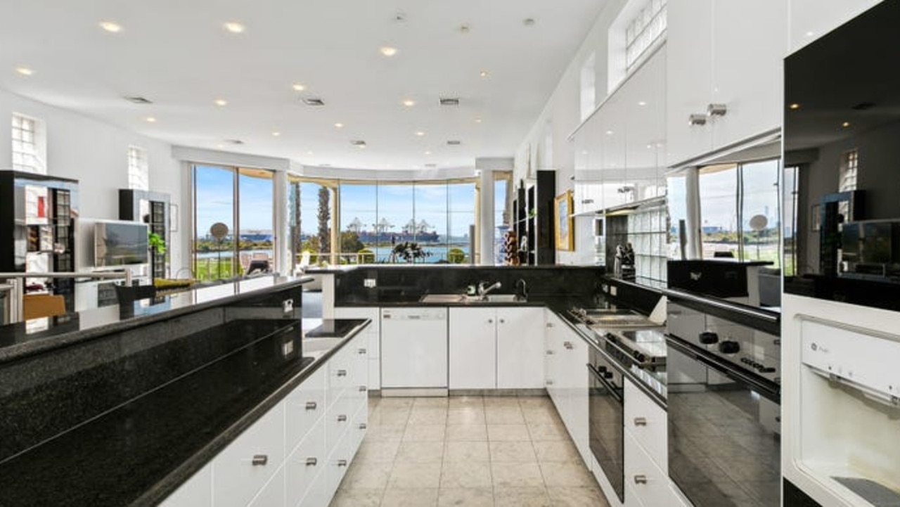 The kitchen features granite benches, high-end Miele appliances, a bench and a butler’s pantry.