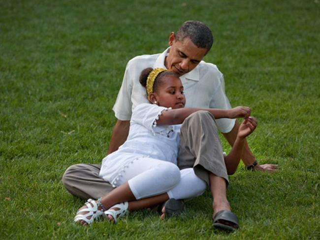 President Barack Obama sits with daughter Sasha during a barbecue with family and friends in celebration of his 49th birthday on the South Lawn of the White House on August 8, 2010. Picture: Pete Souza/The White House