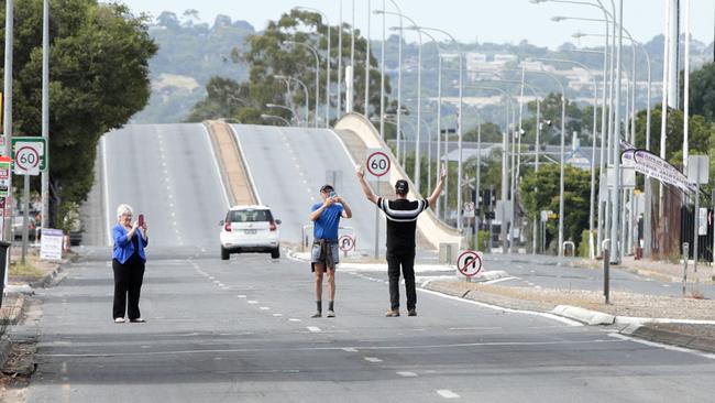 People taking photos on an empty South Rd on Thursday morning after it was closed to traffic. Picture: Tait Schmaal.