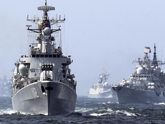 In this May 24, 2014 photo, China's Harbin (112) guided missile destroyer, left, and DDG-139 Ningbo Sovremenny class Type-956EM destroyer, right, take part in a week-long China-Russia 