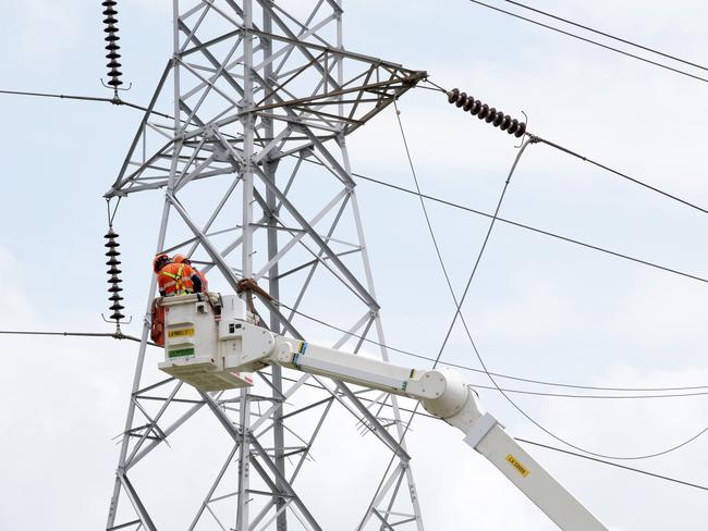 Workers from Endeavour Energy repairing a high-voltage power line that fell over multiple streets and properties around Aquilina Drive at Plumpton. Picture: Jonathan Ng