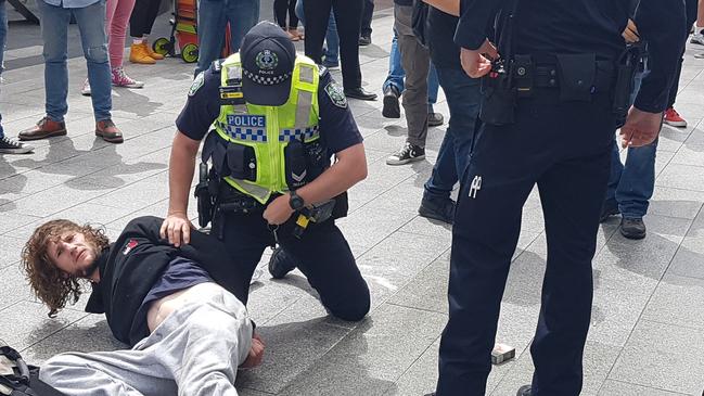 Barry Phillip Siecker is arrested after a busker was allegedly bashed by a ukulele in Rundle Mall. Picture: Shaun Hollis