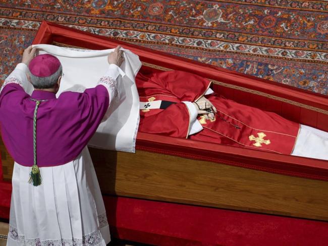 Vatican Master of Ceremonies Archbishop Diego Giovanni Ravelli covers the face of late Pope Francis with a silk cloth before closing his casket in St. Peter's Basilica at the Vatican Friday, April 25, 2025. (Vatican Media via AP)