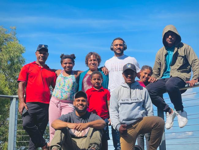 Parents Petrus (left) and Rosemary (centre, standing) with their children Solomon, Faithlyn, Stephanie, Chris, Issac, Adam and Emmanuel are facing being forced out of Australia. Image: supplied