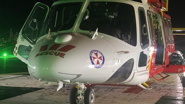 Westpac Lifesaver Rescue Helicopter at Lismore base readying to fly a man in his late teens to the Gold Coast University Hospital with serious head and chest injuries.