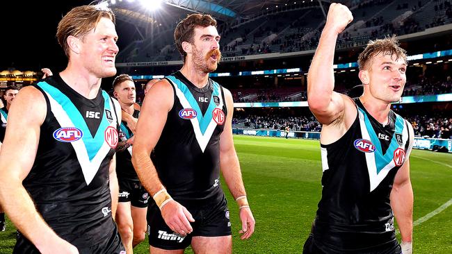 ADELAIDE, AUSTRALIA - AUGUST 08: Tom Jonas ,Scott Lycett of and Ollie Wines of Port Adelaide lead their team off during the round 11 AFL match between the Port Adelaide Power and the Richmond Tigers at Adelaide Oval on August 08, 2020 in Adelaide, Australia. (Photo by Mark Brake/Getty Images)