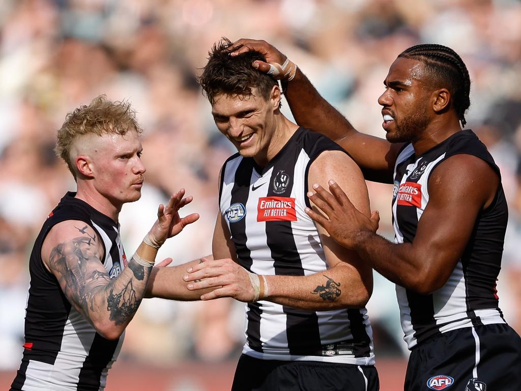 MELBOURNE, AUSTRALIA - APRIL 20: Brody Mihocek of the Magpies celebrates a goal with teammates John Noble and Isaac Quaynor during the 2024 AFL Round 06 match between the Collingwood Magpies and the Port Adelaide Power at the Melbourne Cricket Ground on April 20, 2024 in Melbourne, Australia. (Photo by Dylan Burns/AFL Photos via Getty Images)