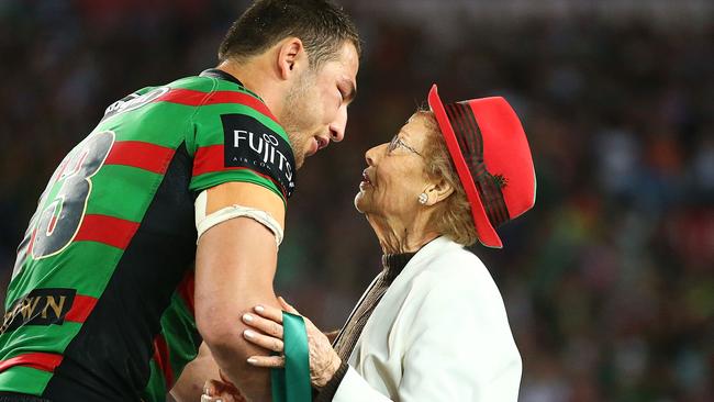 Sam Burgess is presented with the Clive Churchill Medal by Joyce Churchill.