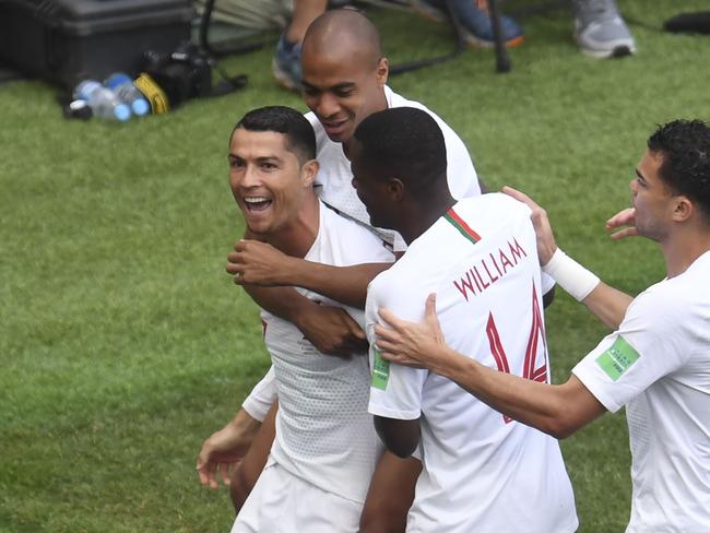 Cristiano Ronaldo (L) celebrates with teammates after heading home the eventual winner. Picture: AFP