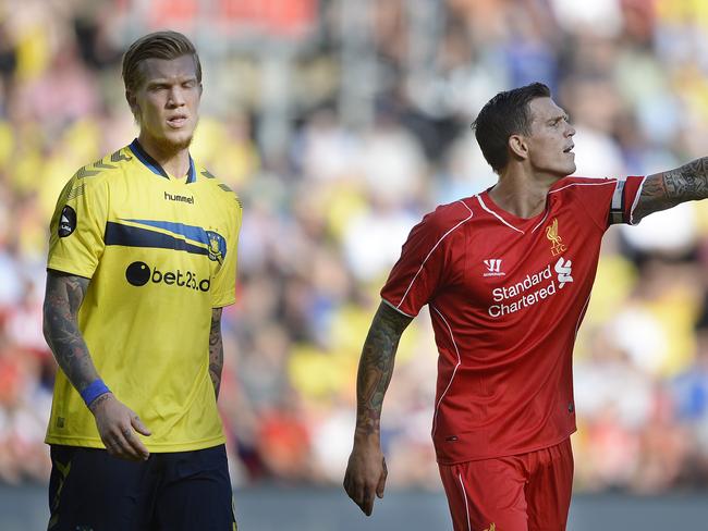 Simon Makienok of Brondby (L) and Daniel Agger of Liverpool walk on the pitch on July 16, 2014 at Broendby stadium suringa test match between Brondby and Liverpool. Broendby won 2-1. AFP Photo / / Scanpix DENMARK / Liselotte Sabroe / DENMARK OUT