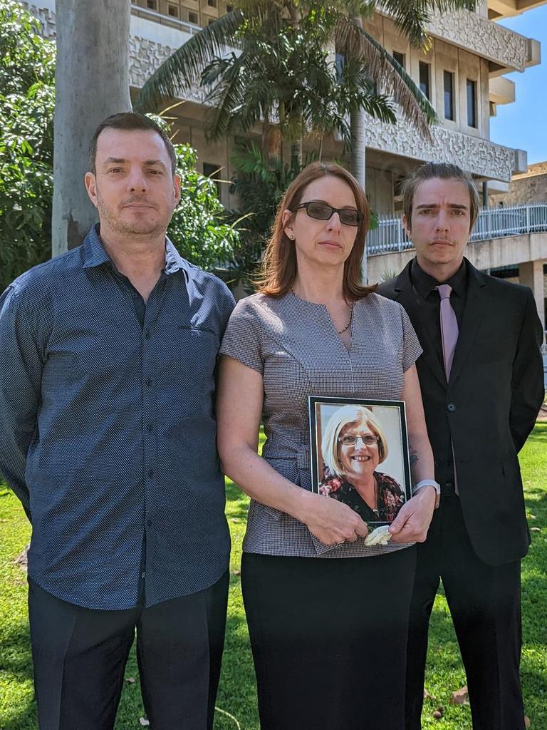 Siblings Dean Fabris, Michelle Graham, and Raymond Fabris pose with a photo of their late mother Julie Hatton. Ms Hatton was killed on September 10, 2019 when a car driven by Aaron Joshua McRae collided with her vehicle on Woolcock and Weston Sts.