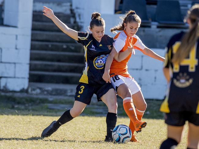 Mudgeeraba's Lucy Rowell (left) takes on the Brisbane Roar at Sid Bigg Park last season. Picture: Jerad Williams