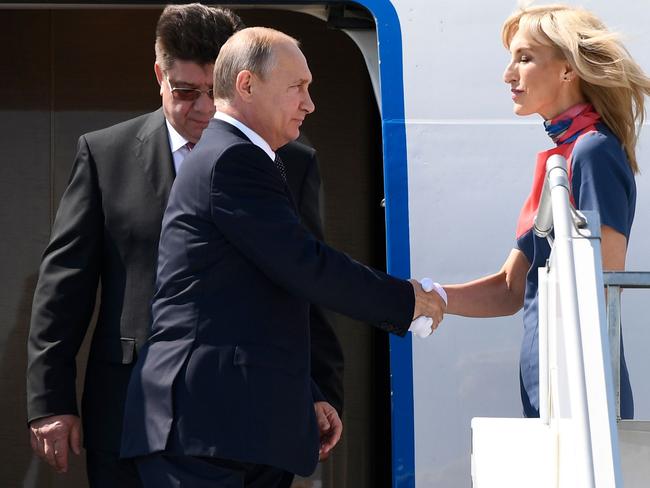 Russian President Vladimir Putin and Russia’s ambassador to Finland Pavel Kuznetsov arrive at Helsinki-Vantaa Airport.