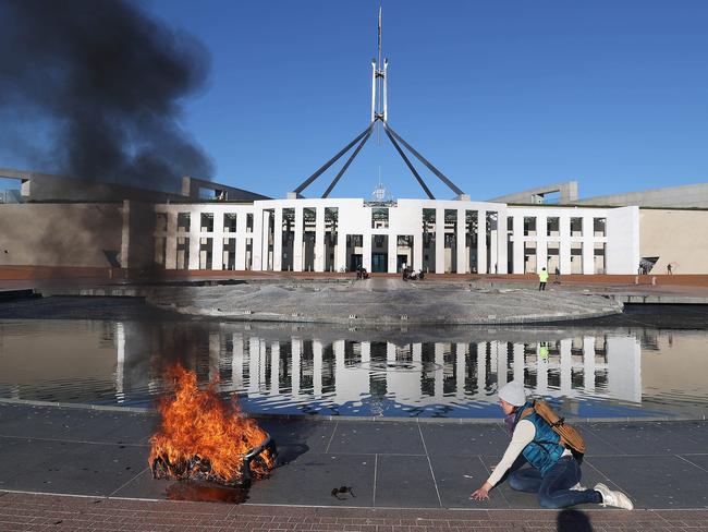 Extinction Rebellion protesters lighting a baby's pram outside Parliament House. Picture: NCA NewsWire / Gary Ramage