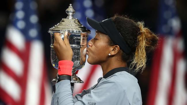 Naomi Osaka of Japan poses with the championship trophy after winning the Women's Singles finals match against Serena Williams.