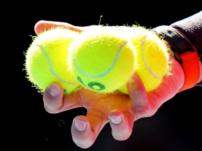 A detail as Rafael Nadal of Spain holds tennis balls as he prepares to serve during his third round match against Pablo Carreno Busta of Spain on day six of the Australian Open tennis tournament at Rod Laver Arena in Melbourne, Saturday, January 25, 2020.(AAP Image/Scott Barbour) NO ARCHIVING, EDITORIAL USE ONLY