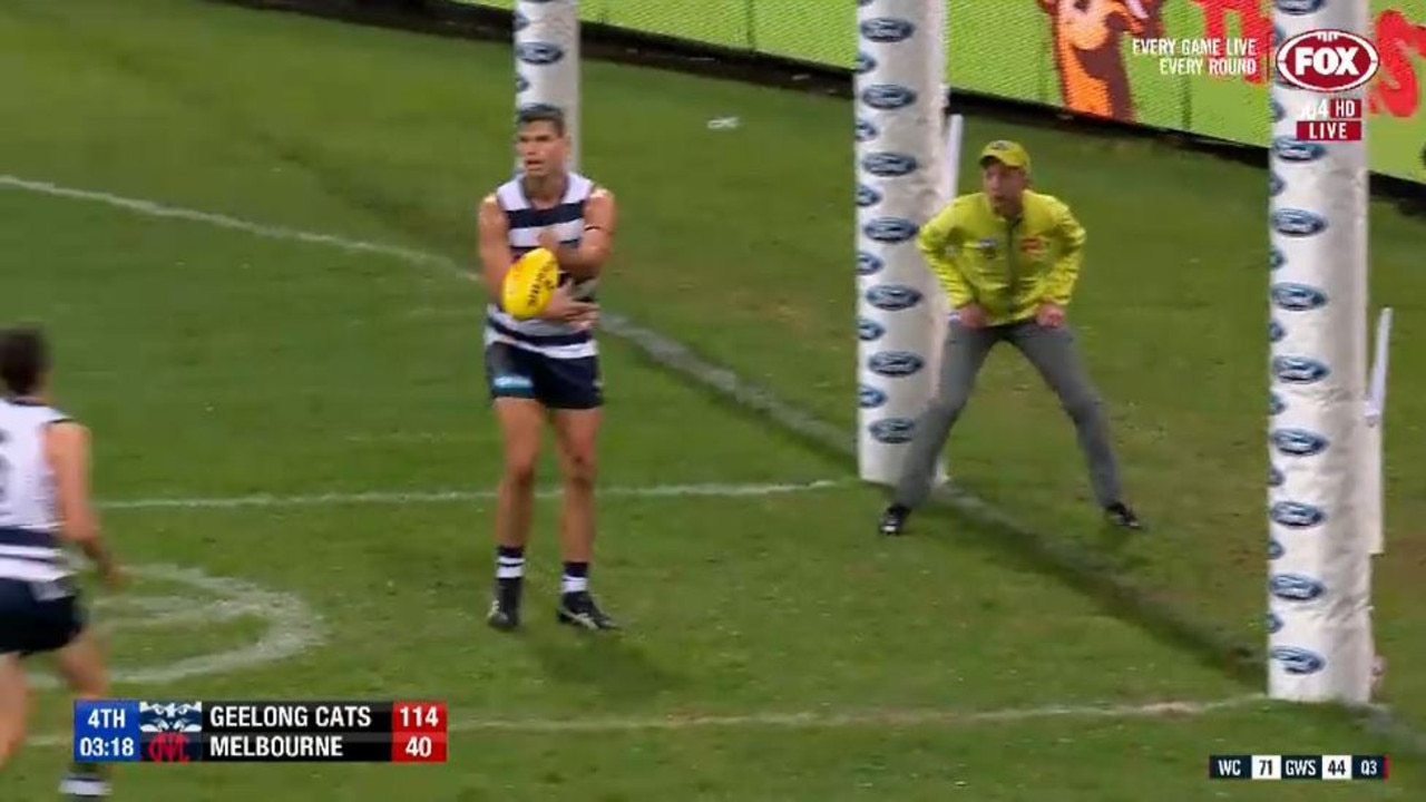 Tom Hawkins handballs to Jordan Clark to give the young defender his first AFL goal.