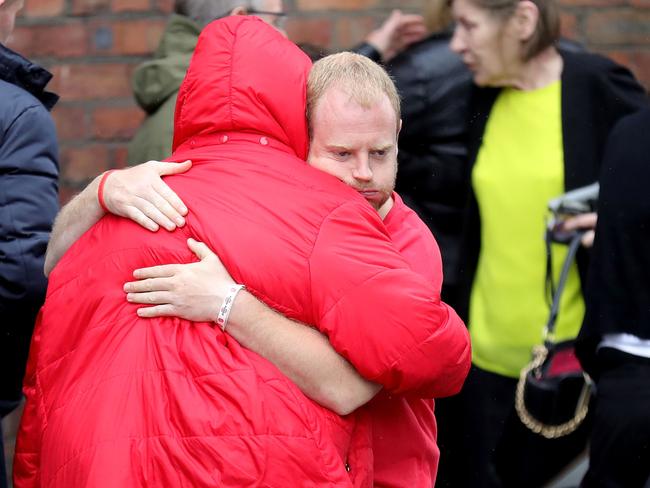 Family members of the victims react after being told of the decision to press criminal charges.