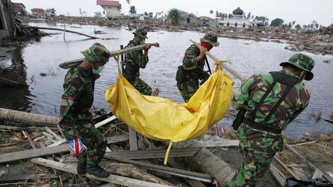 Indonesian TNI soldiers use a makeshift stretcher to remove bodies, victims of the Boxing Day tsunami in Banda Aceh, Sumatra.