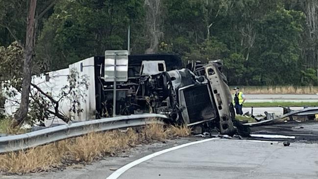 A truck rolled onto its side before catching fire. Picture: Savannah Pocock