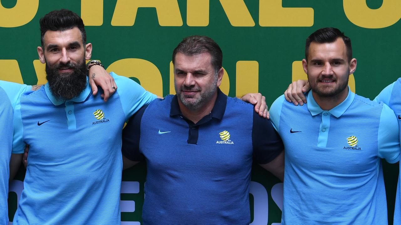 Australian Socceroos head coach Ange Postecoglou and players pose for a photograph