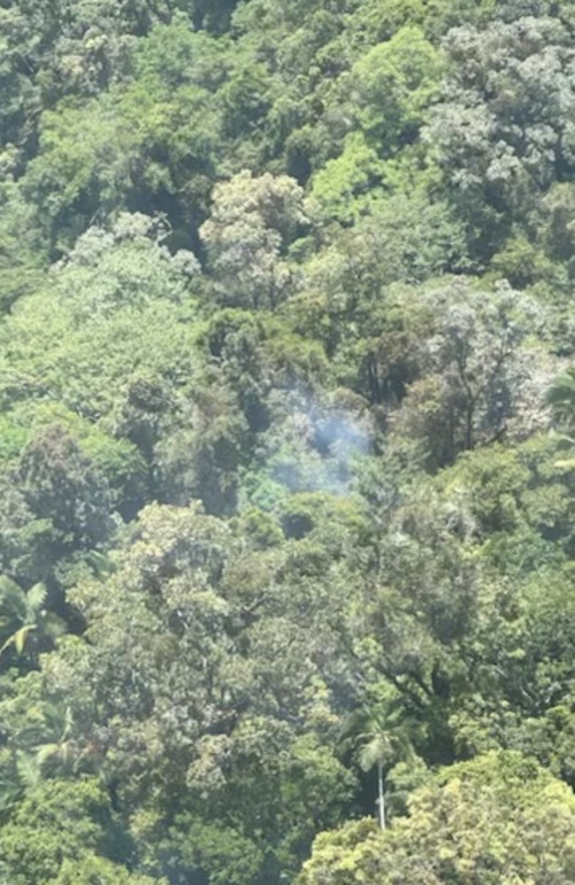 Smoke rising from the thick tree coverage of a mountain range north of Okuloo and Netherdale where it is understood a plane crashed on Saturday, October 28, 2023. Picture: RACQ CQ Rescue