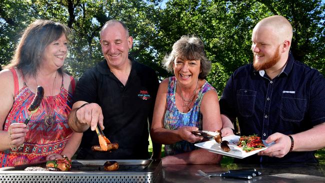 COOK UP Sharron Hill, Bruce's Meat owner &amp; butcher Trevor Hill, Alison Cragg and Gage Bassham plate up sausages at Mitcham Reserve, Mitcham. Picture: Bianca De Marchi