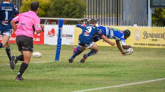 Benaiah Kambanei flies over the line for Past Brothers. Picture: Brian Cassidy