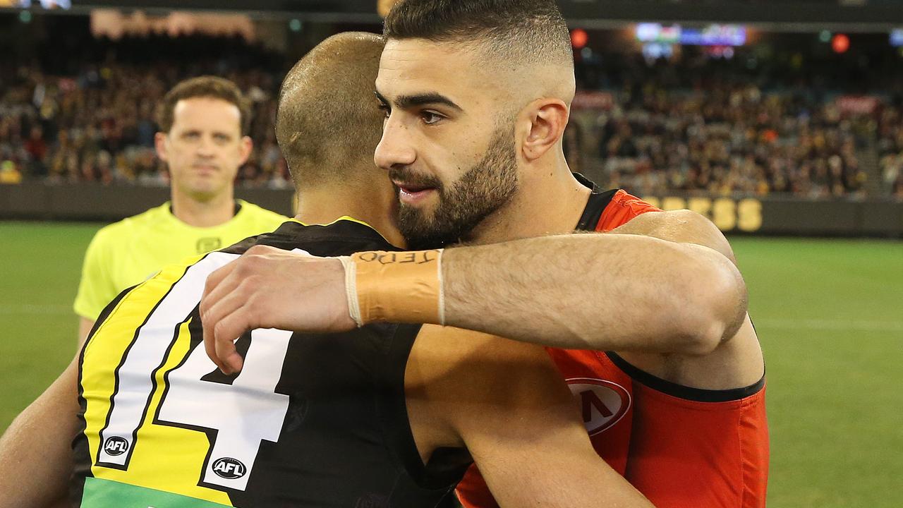 Richmond's Bachar Houli and Essendon's Adam Saad hug at the coin toss. Photo: Michael Klein