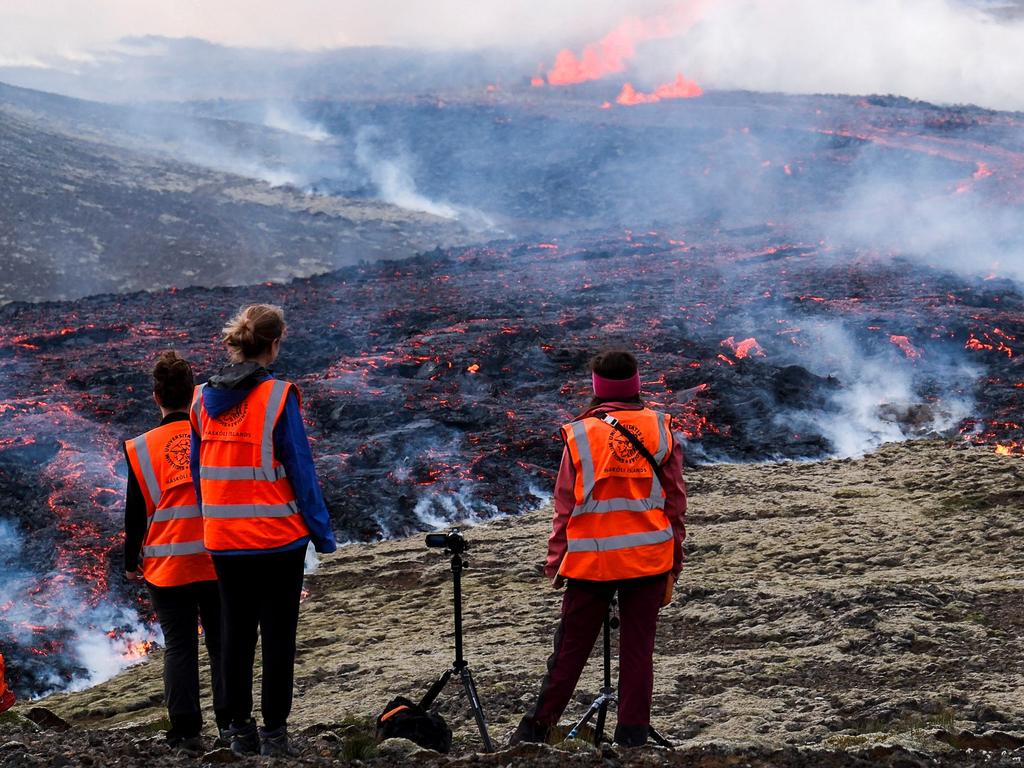 University of Iceland’s observers stand in front of smoke billowing from flowing lava on July 10, 2023. Picture: Kristinn Magnusson / AFP