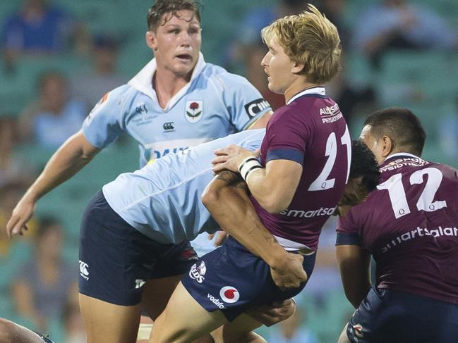 Israel Folau of the Waratahs tackles Tate McDermott of the Reds during the Round 4 Super Rugby match between the NSW Waratahs and the Queensland Reds at the SCG in Sydney, Saturday, March 9, 2019. (AAP Image/Craig Golding) NO ARCHIVING, EDITORIAL USE ONLY