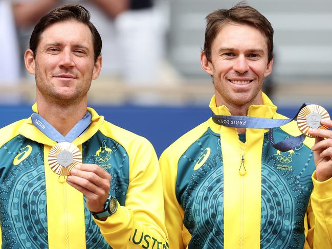 PARIS, FRANCE - AUGUST 03: Gold medallists Matthew Ebden and John Peers of Team Australia celebrate on the podium during the Tennis Men's Doubles medal ceremony after the Tennis Men's Doubles matches on day eight of the Olympic Games Paris 2024 at Roland Garros on August 03, 2024 in Paris, France. (Photo by Matthew Stockman/Getty Images)