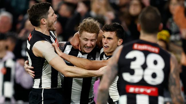 MELBOURNE, AUSTRALIA - AUGUST 17: (L-R) Jack Crisp, Beau McCreery and Nick Daicos of the Magpies celebrate during the 2024 AFL Round 23 match between the Collingwood Magpies and the Brisbane Lions at The Melbourne Cricket Ground on August 17, 2024 in Melbourne, Australia. (Photo by Michael Willson/AFL Photos via Getty Images)