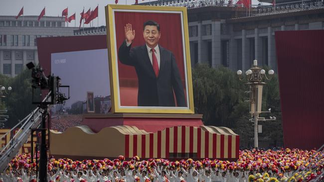 A giant portrait of Chinese President Xi Jinping is carried atop a float at a parade to celebrate the 70th Anniversary of the founding of the People's Republic of China in 1949 , at Tiananmen Square in 2019.