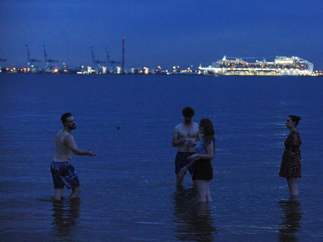 People escaping the heat enjoy a swim at Middle Park Beach. Picture: Andrew Henshaw