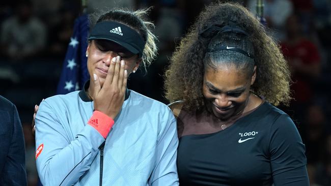 TOPSHOT - US Open Womens Single champion Naomi Osaka of Japan (L) with Serena Williams of the US during their Women's Singles Finals match at the 2018 US Open at the USTA Billie Jean King National Tennis Center in New York on September 8, 2018. (Photo by TIMOTHY A. CLARY / AFP)