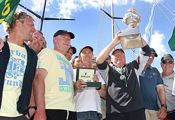 Tattersall's Cup ... Bob Steel hoists aloft the trophy. James Kerr