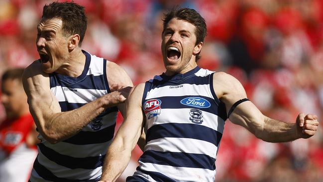 Isaac Smith and Jeremy Cameron celebrate a goal in Geelong’s first-half romp.