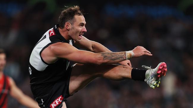 ADELAIDE, AUSTRALIA - APRIL 05: Jeremy Finlayson of the Power kicks the ball during the 2024 AFL Round 04 match between the Port Adelaide Power and the Essendon Bombers at Adelaide Oval on April 05, 2024 in Adelaide, Australia. (Photo by James Elsby/AFL Photos via Getty Images)