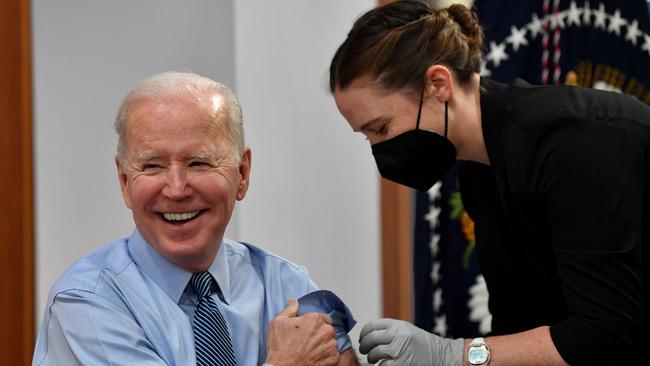 US President Joe Biden receives a second booster shot of a Covid-19 vaccine in March last year. Governments are now cutting back on orders.